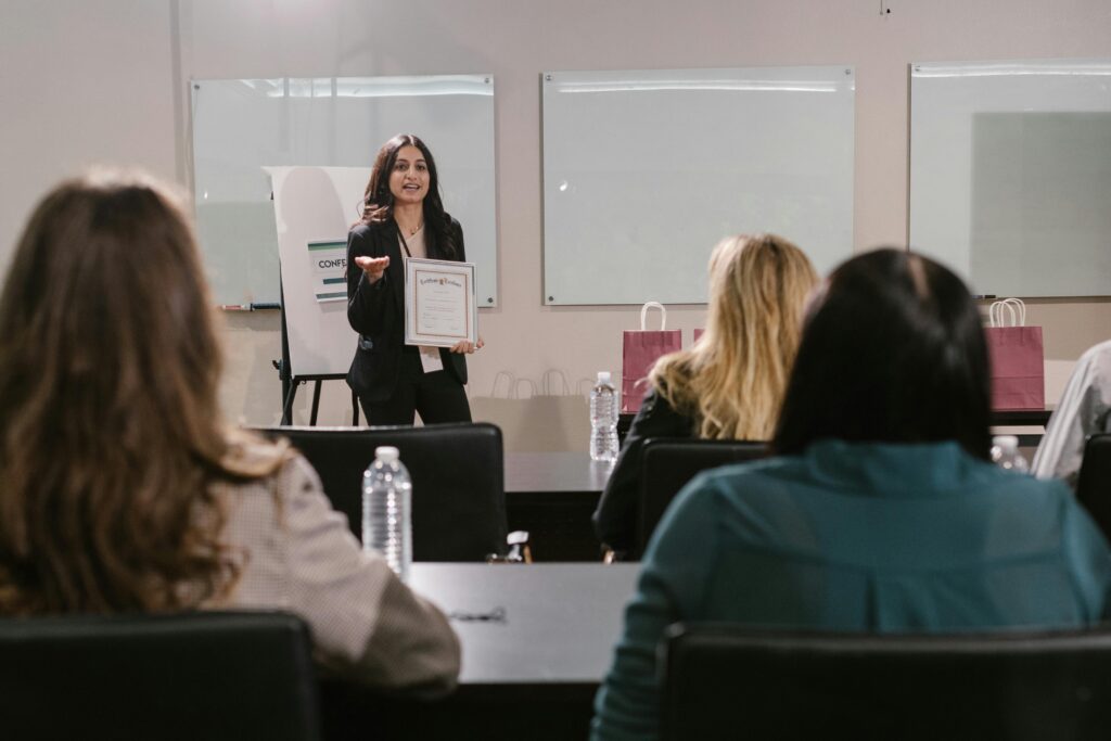 Mujer impartiendo un taller sobre cómo trabajar las habilidades blandas a un grupo atento.